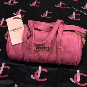 Juicy Couture hot pink mini Barrel bag with adjustable strap.